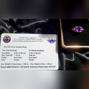 Silver ring with a 1.15 ct oval amethyst surrounded by 6 amethysts  .65 ct